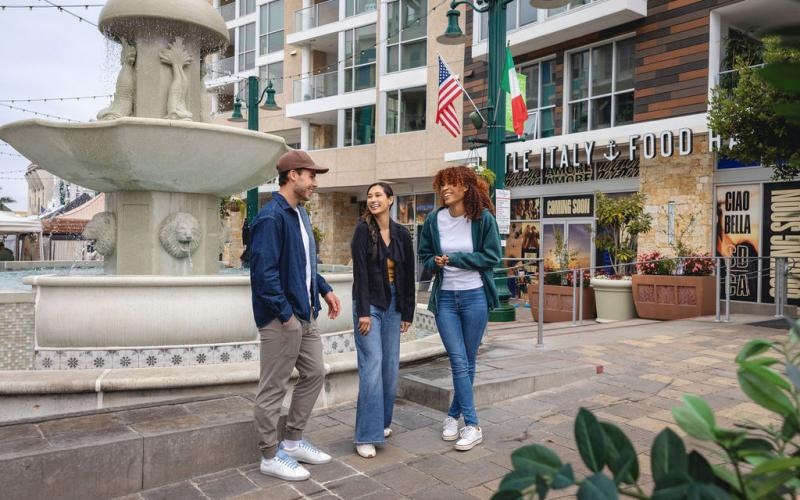 Find your perfect fit at Ancora a group of people standing next to a fountain