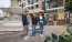 a group of people standing next to a fountain
