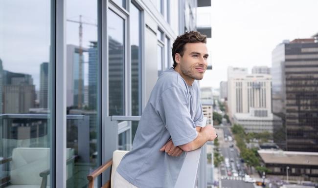 a man leaning against a window
